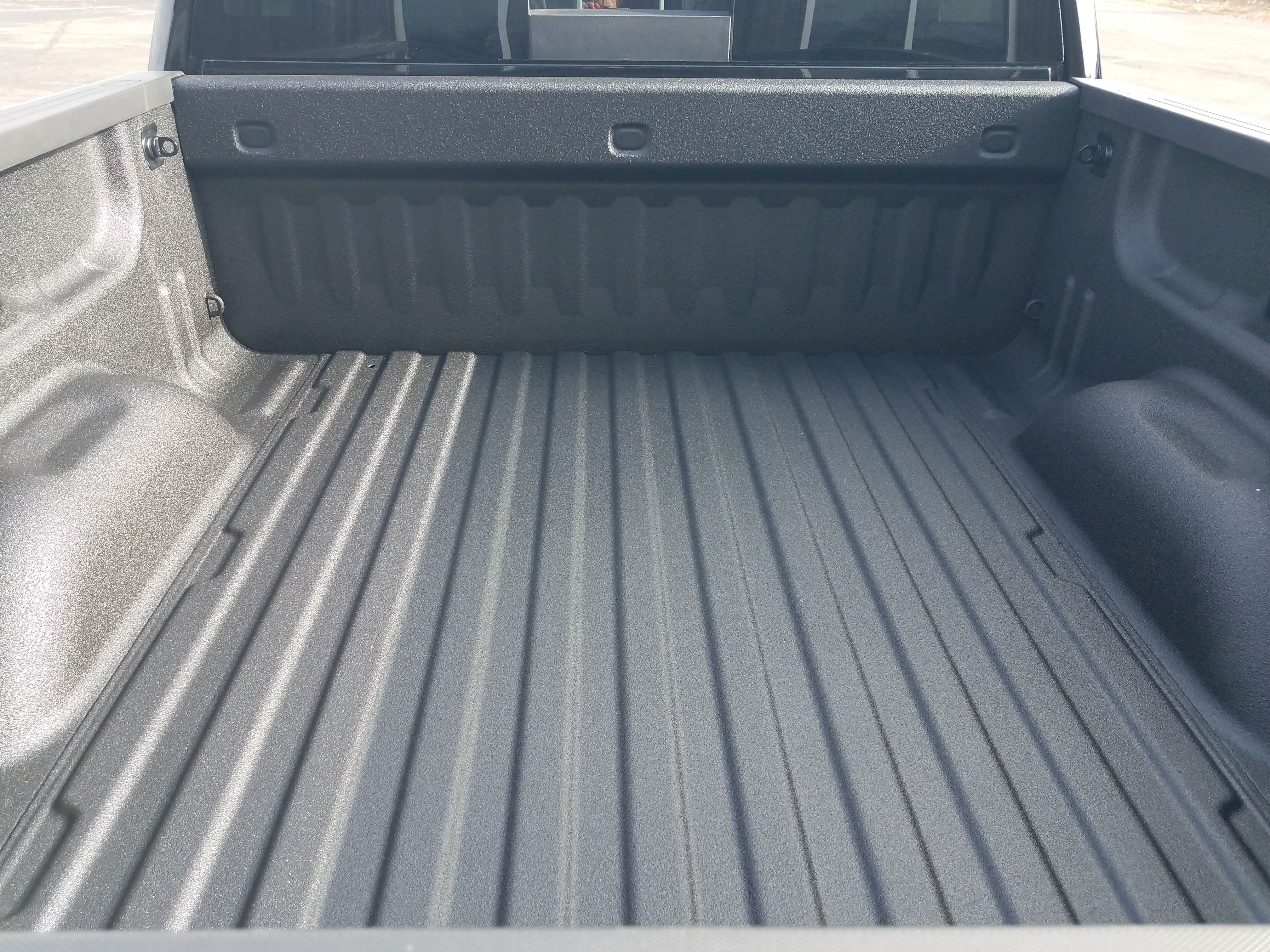 Applicator spraying polyurea underbody coating